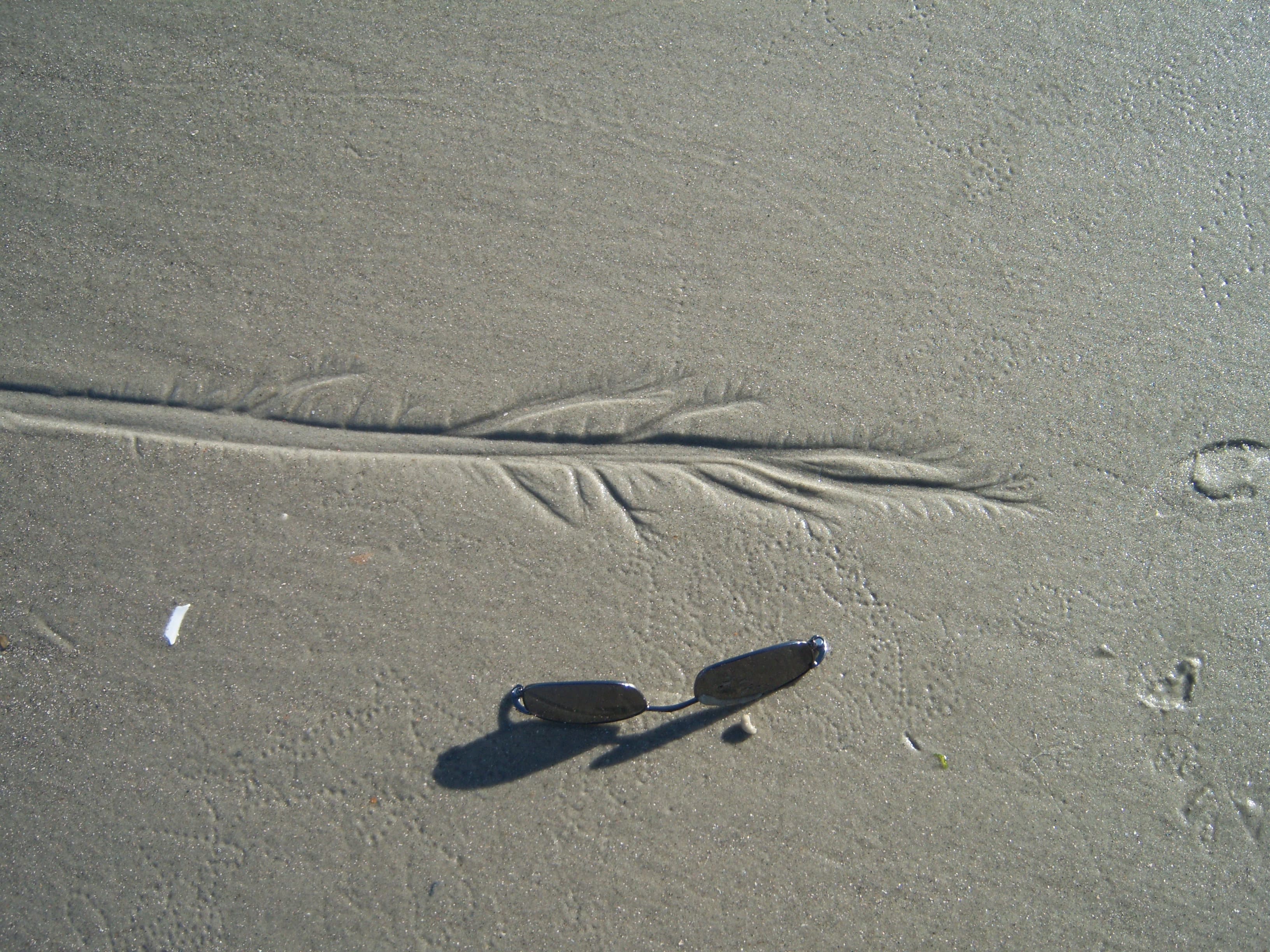 Erosion Pattern in Sand with Sunglasses