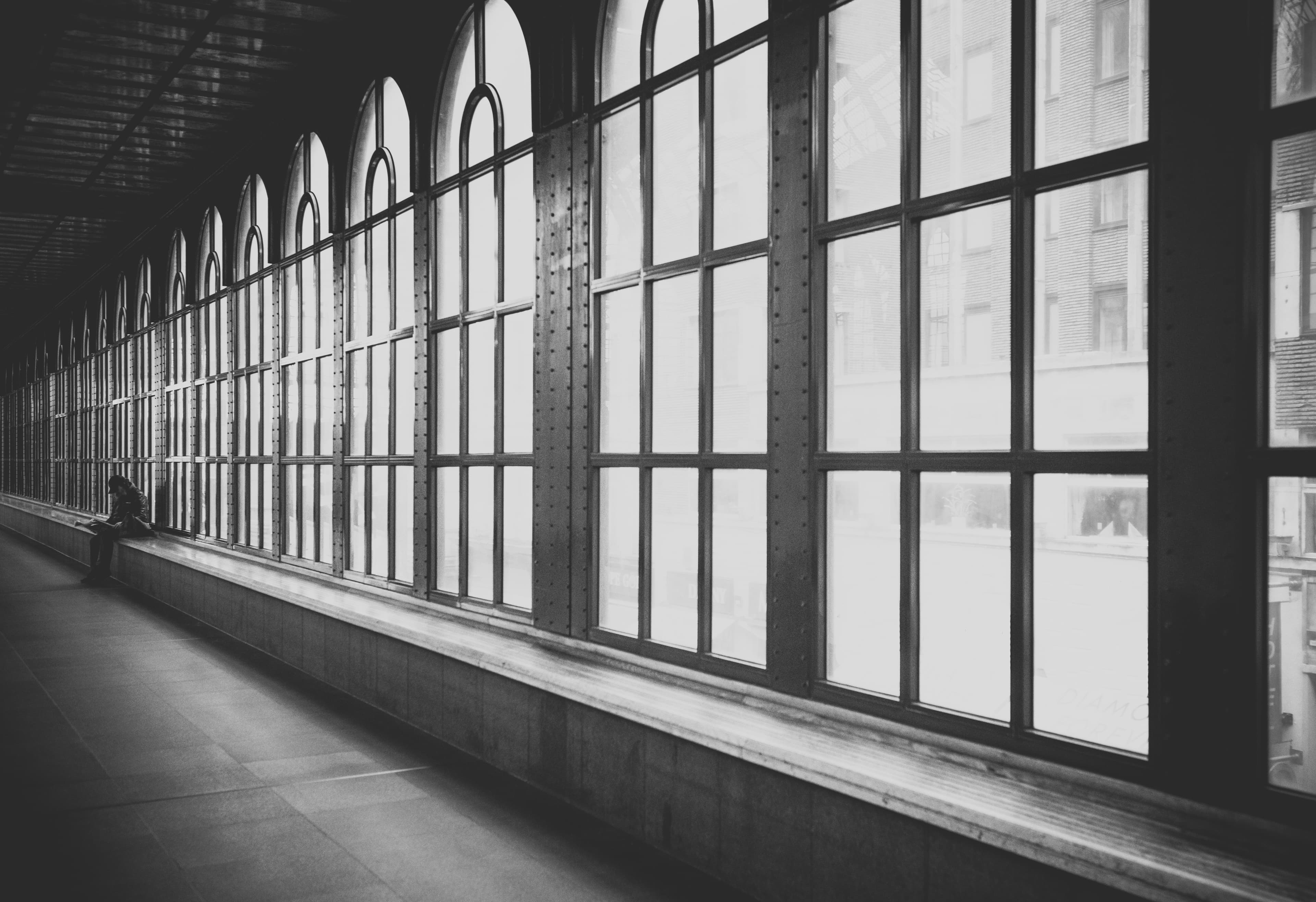 Person sitting in hallway (Unsplash)