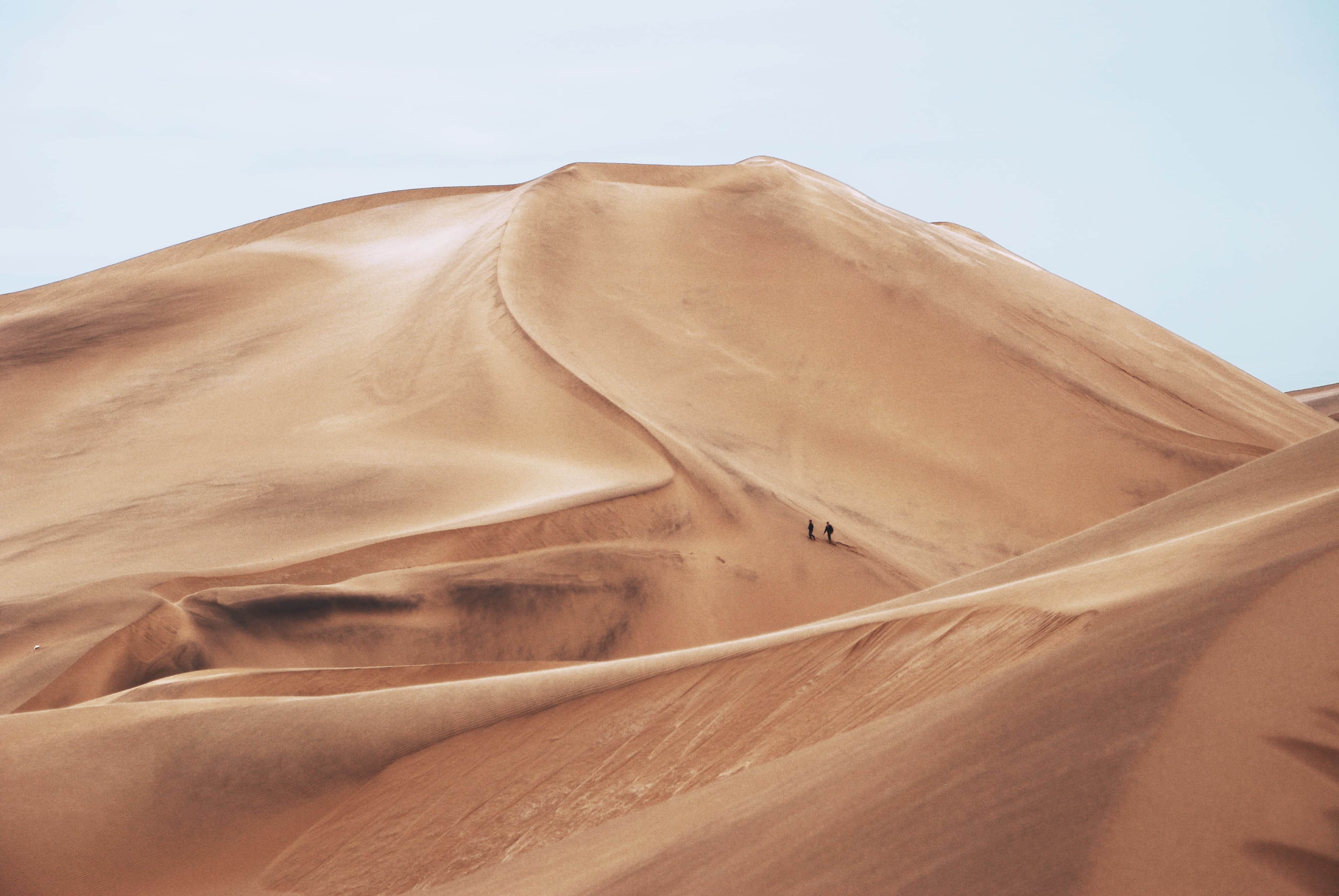 Hiking Through Sand Dunes (Unsplash)
