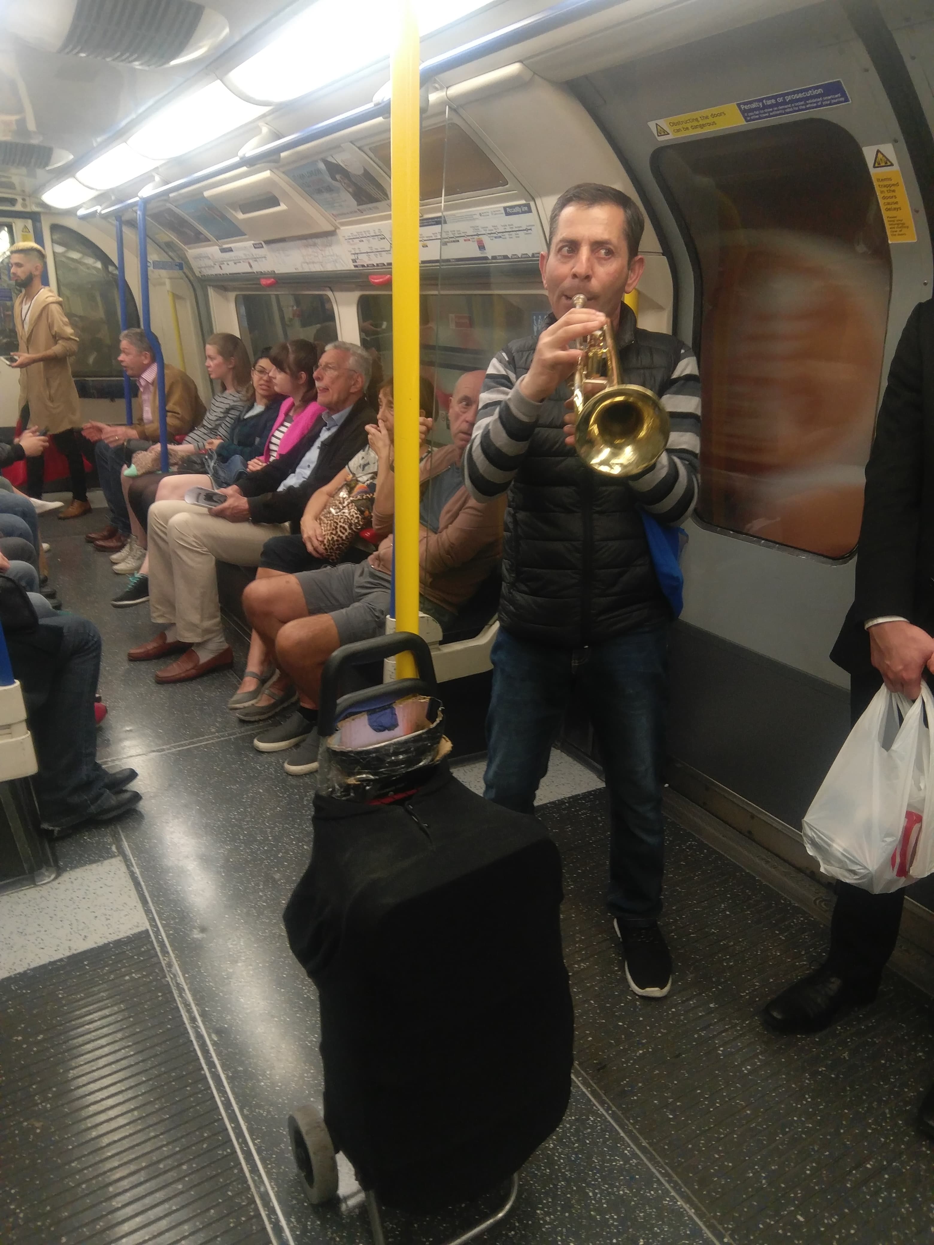 Musician performing in Piccadilly line