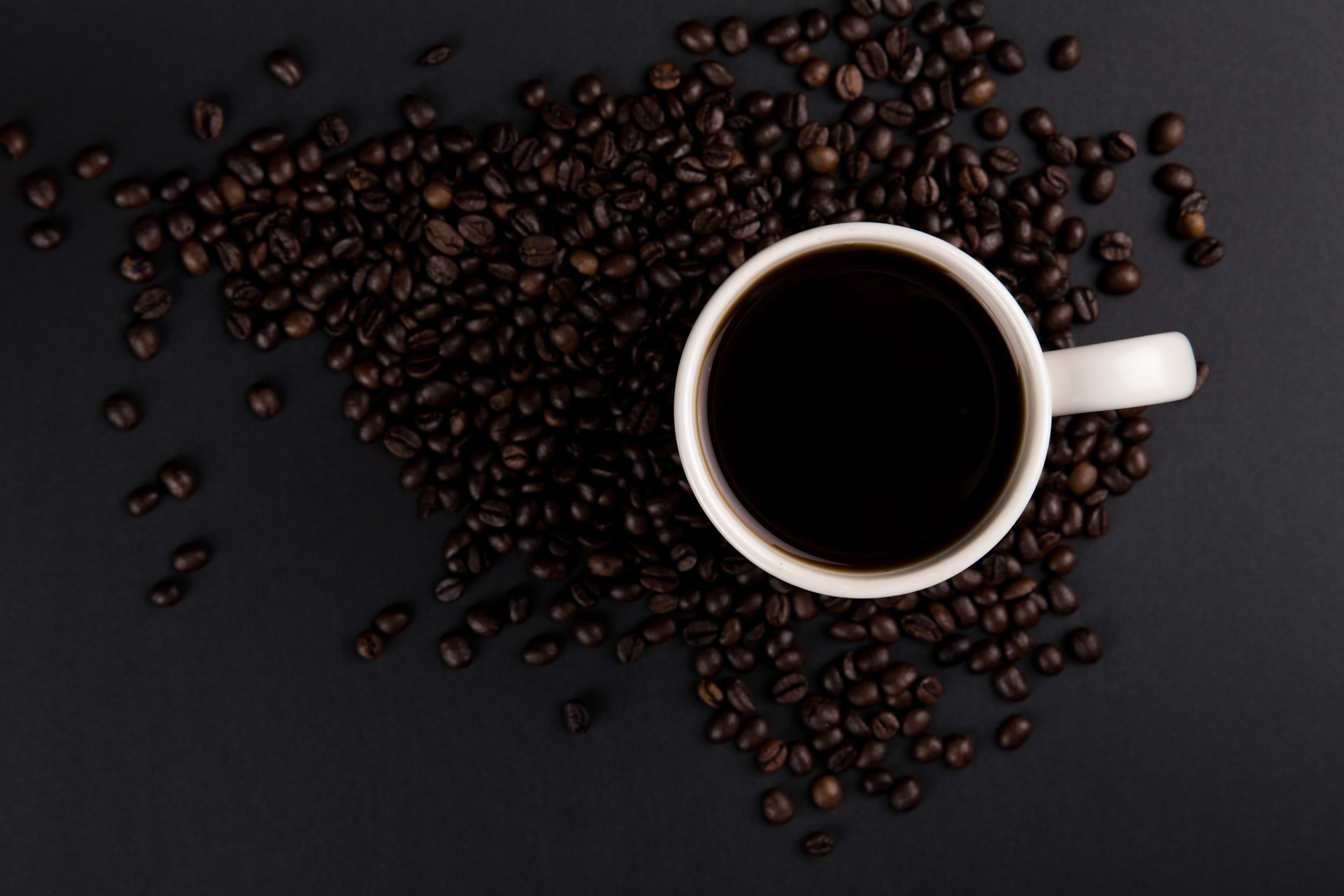Coffee cup on coffee beans