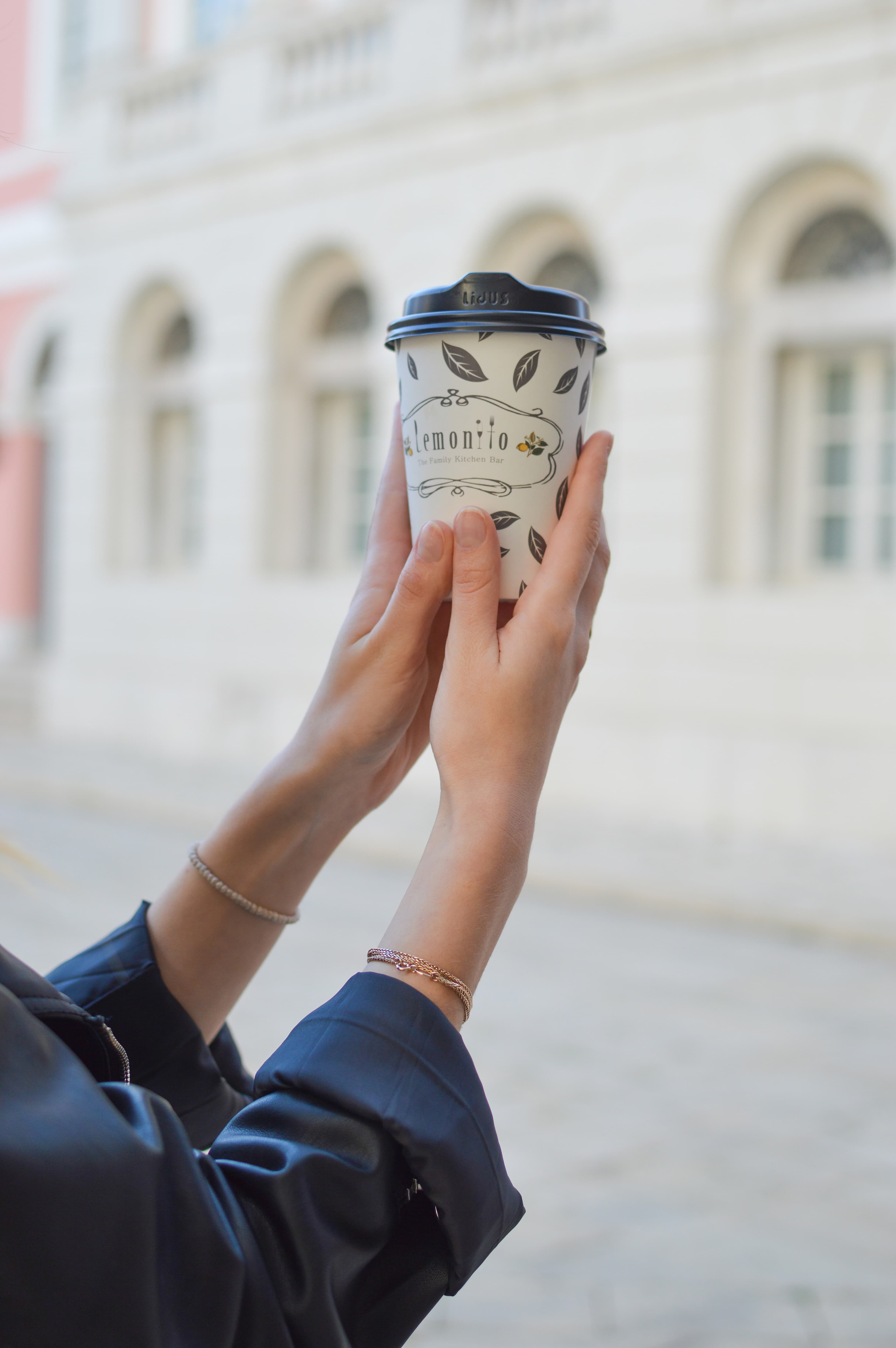 Coffee cup in woman's hands (Unsplash)