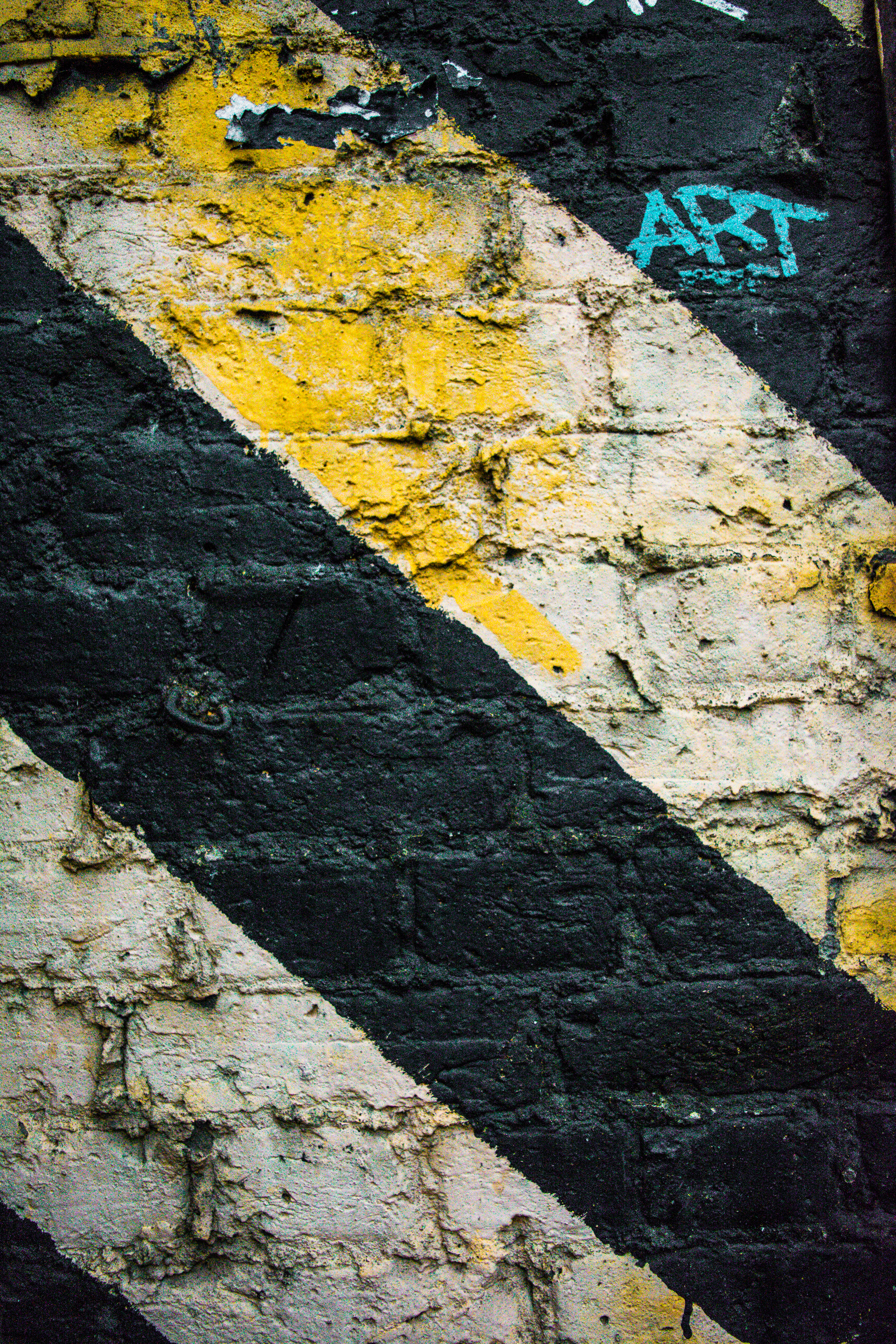 Stripes on brick wall. (Unsplash)