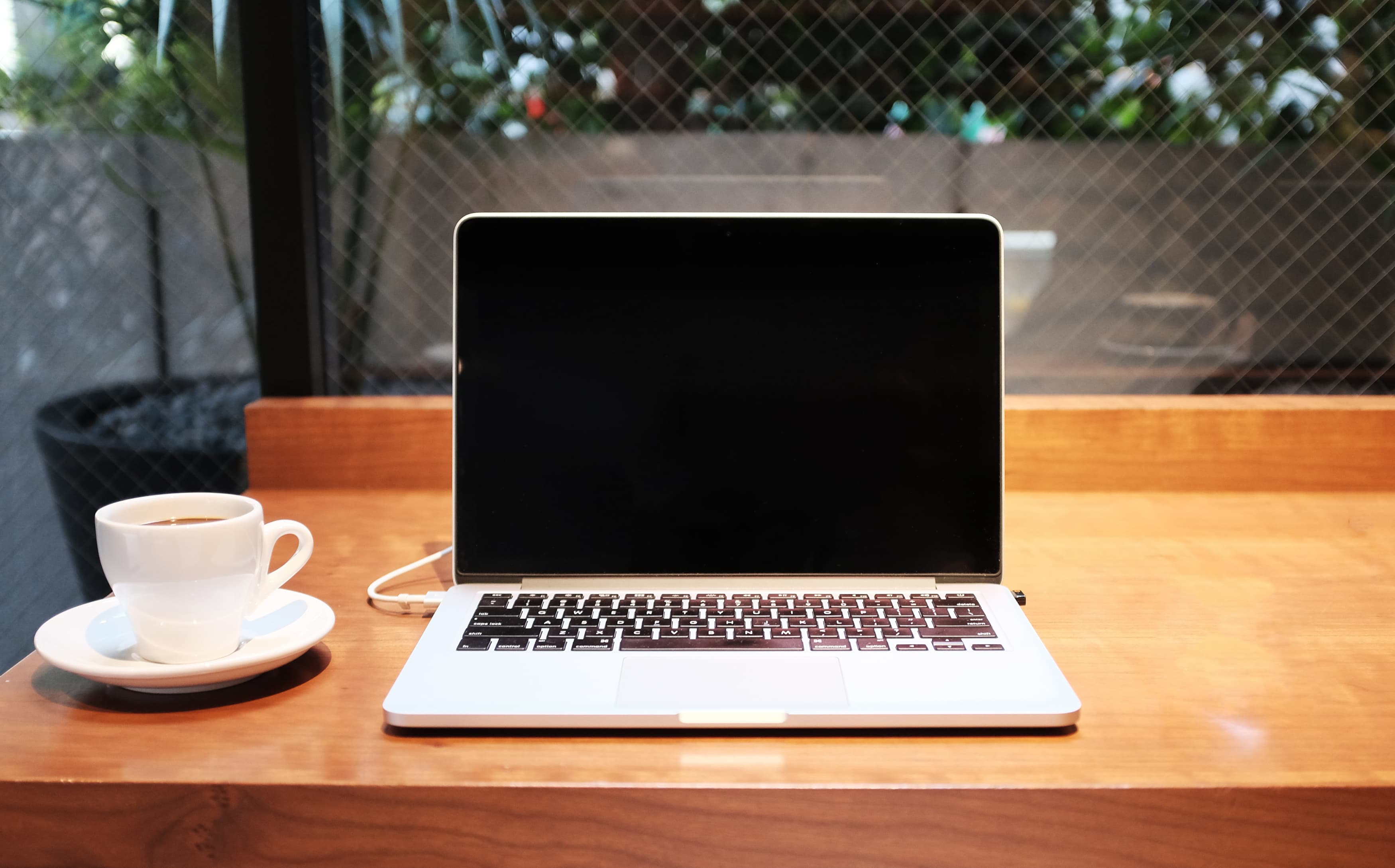 White cup and MacBook (Unsplash)