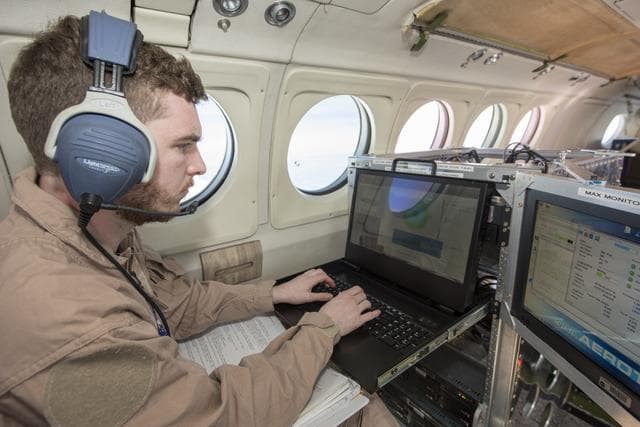 Instrument Operator Monitors Wind Data