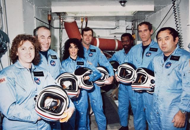 Crew pose for portrait while training at KSC