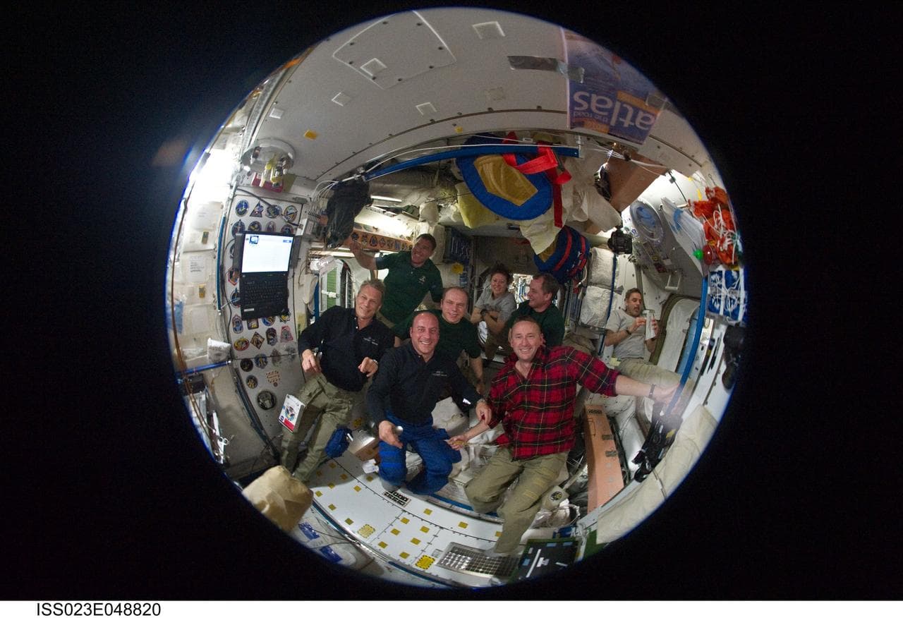 Fisheye View of Crewmembers Sharing a Meal in the SM