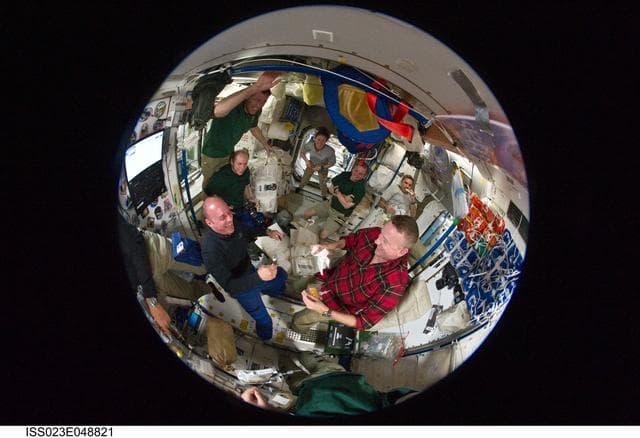 Fisheye View of Crewmembers Sharing a Meal in the SM