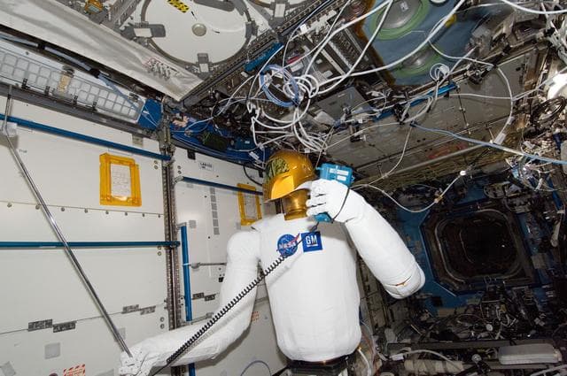 Robonaut 2 Humanoid Robot holds instrument to measure air velocity