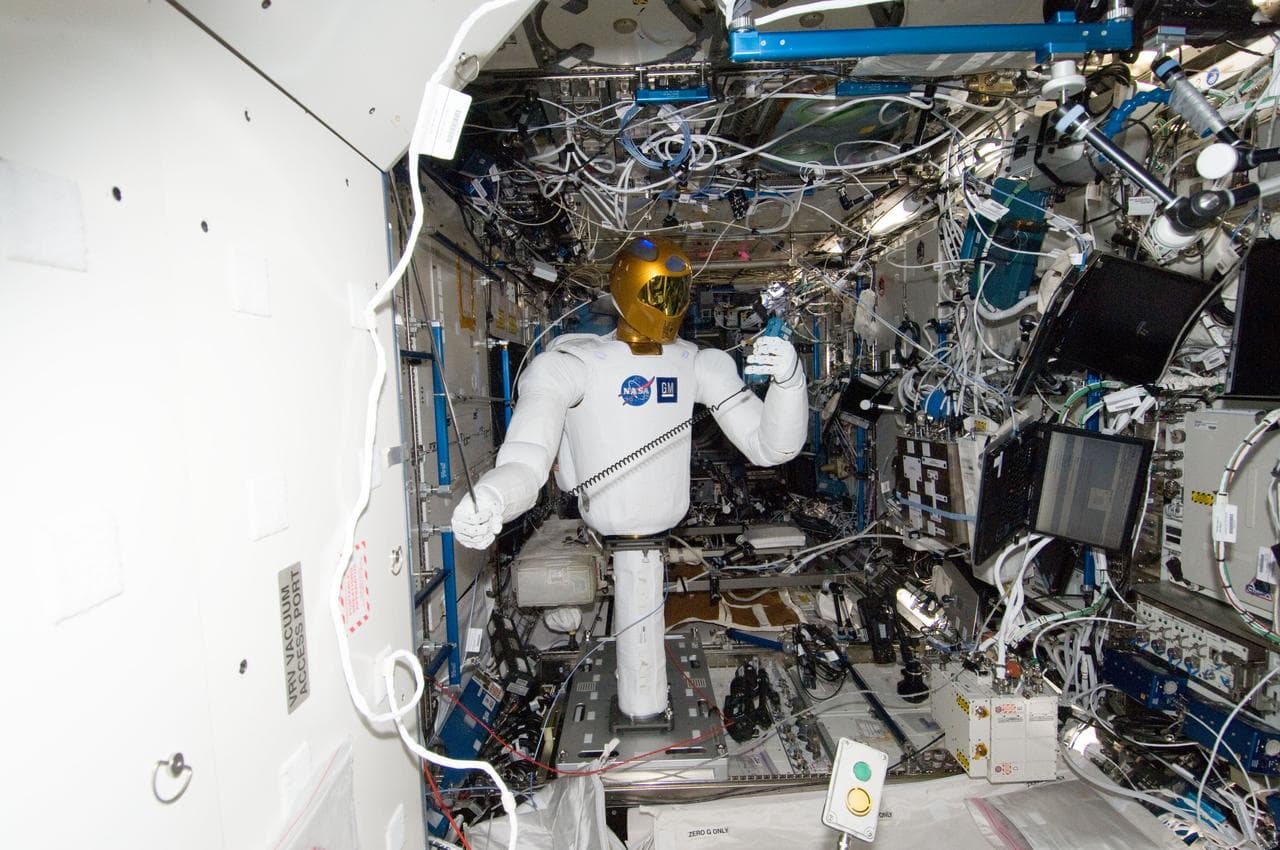 Robonaut 2 Humanoid Robot holds instrument to measure air velocity