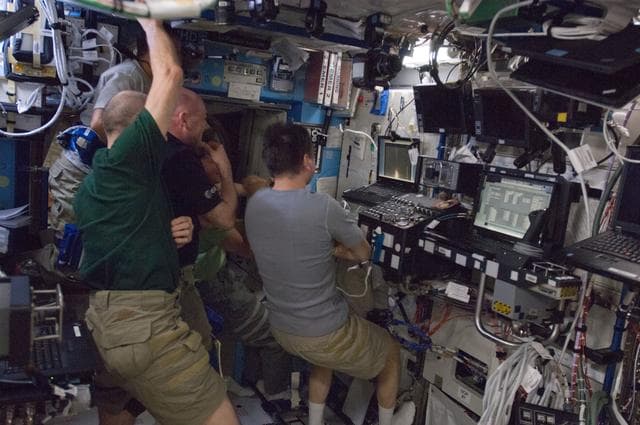 Crewmembers watch Dragon Launch on Computer Screen