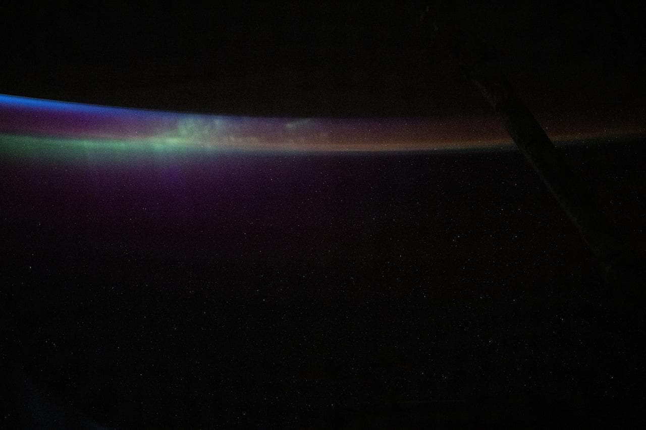 The aurora australis blends into Earth's atmospheric glow