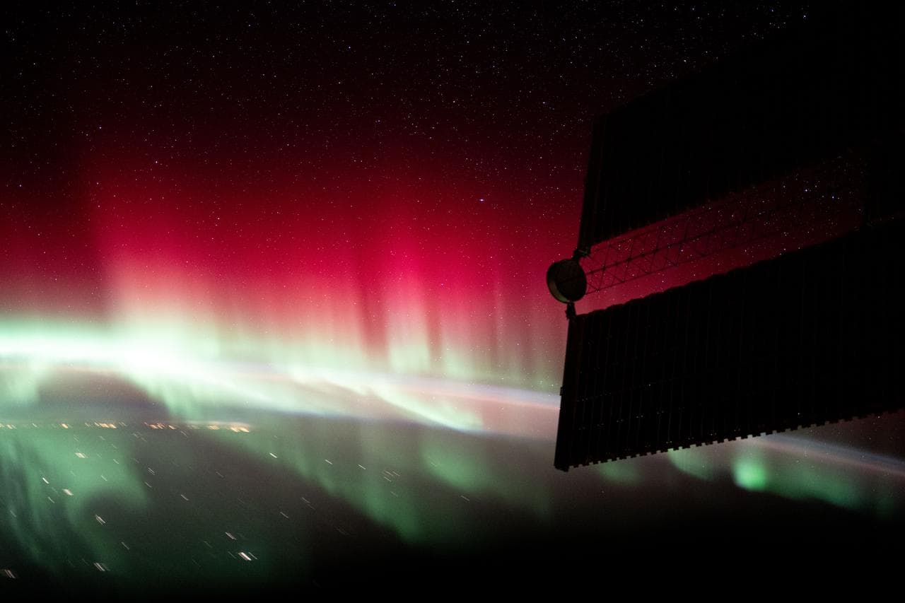 A red and green aurora shimmers brightly above Ontario, Canada