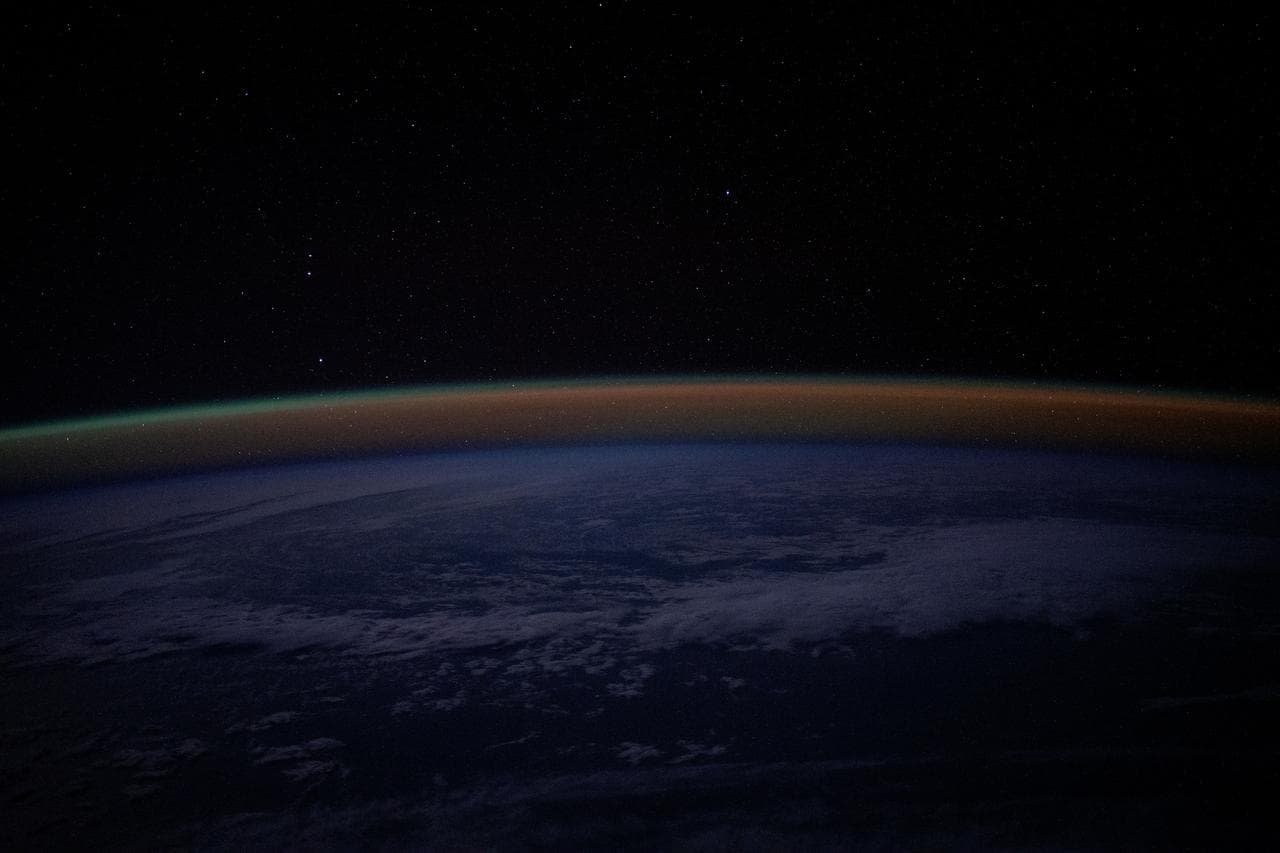 An atmospheric glow blankets Earth's horizon