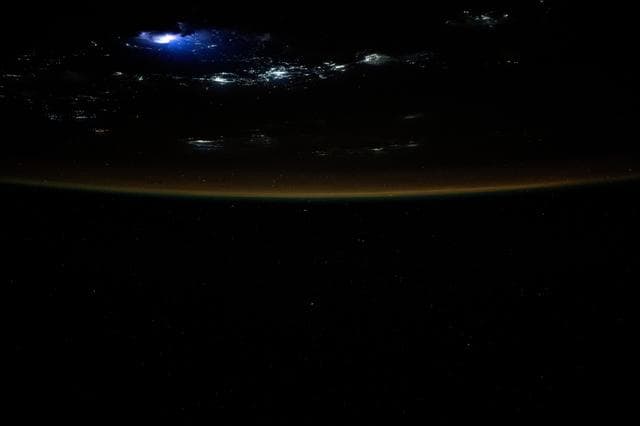 Lightning illuminates the clouds above Southeast Asia