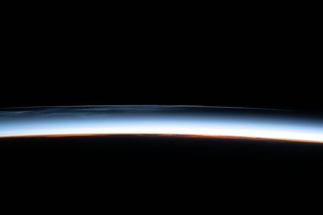 Noctilucent clouds are pictured above the North Pacific Ocean