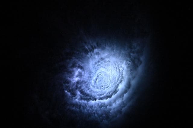 Lightning illuminates the cloud tops of Tropical Storm Erick