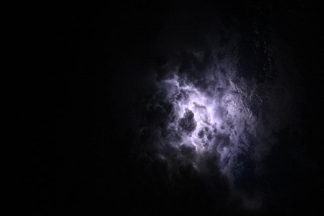 Lightning illuminates the cloud tops of Category 1 Hurricane Erick