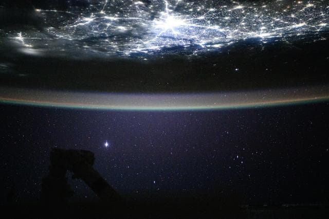 The city lights of New Delhi, India, underneath a starry night sky