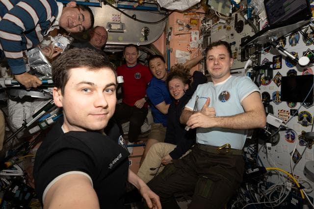 The Expedition 73 crew gather for a portrait during dinnertime
