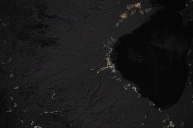 Villages light up the coastline in this nighttime image of Lake Sevan