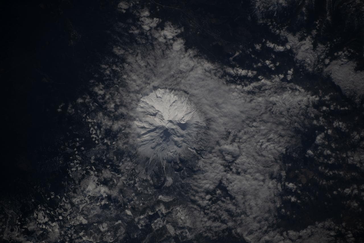 The snow-capped Mount Shasta is surrounded by clouds