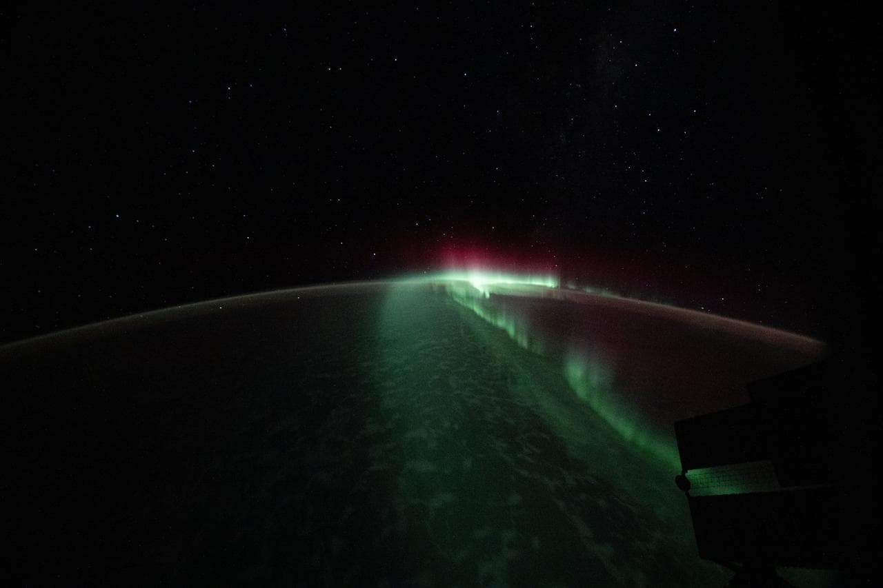 The aurora australis streams serenely above the Indian Ocean