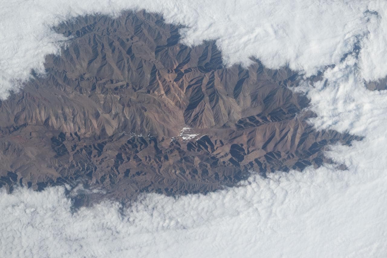 Clouds surround the rugged peaks of the Andes mountain range