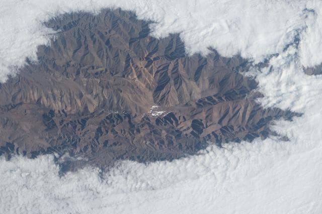 Clouds surround the rugged peaks of the Andes mountain range