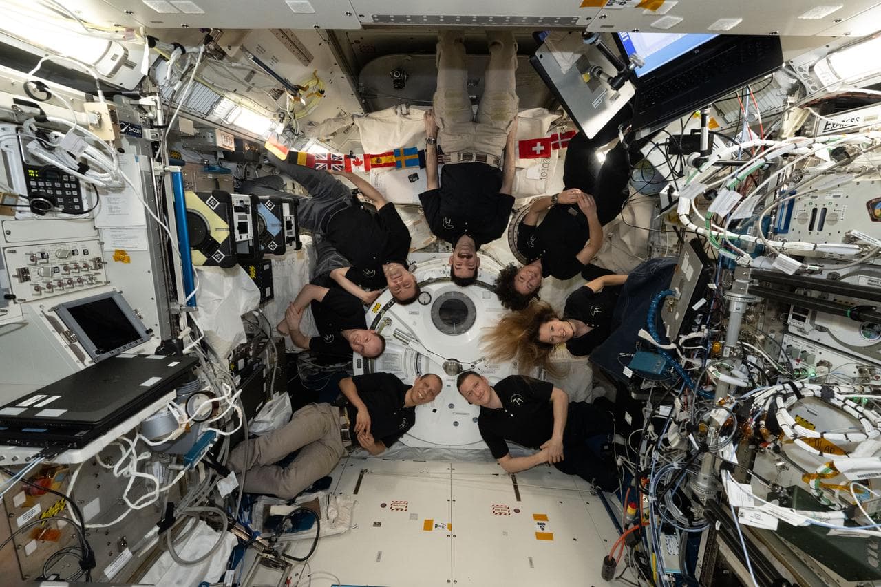 The seven-member Expedition 74 crew poses together for a fun portrait