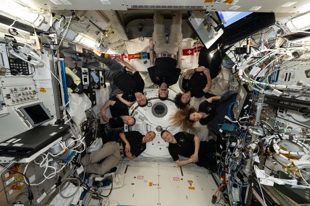 The seven-member Expedition 74 crew poses together for a fun portrait