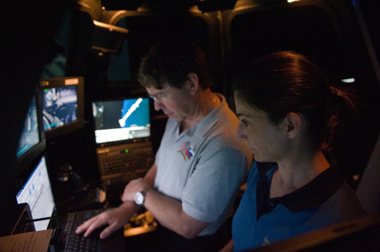 STS-133 crew members Mike Barratt and Nicole Stott in cupola