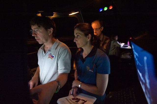 STS-133 crew members Mike Barratt and Nicole Stott in cupola