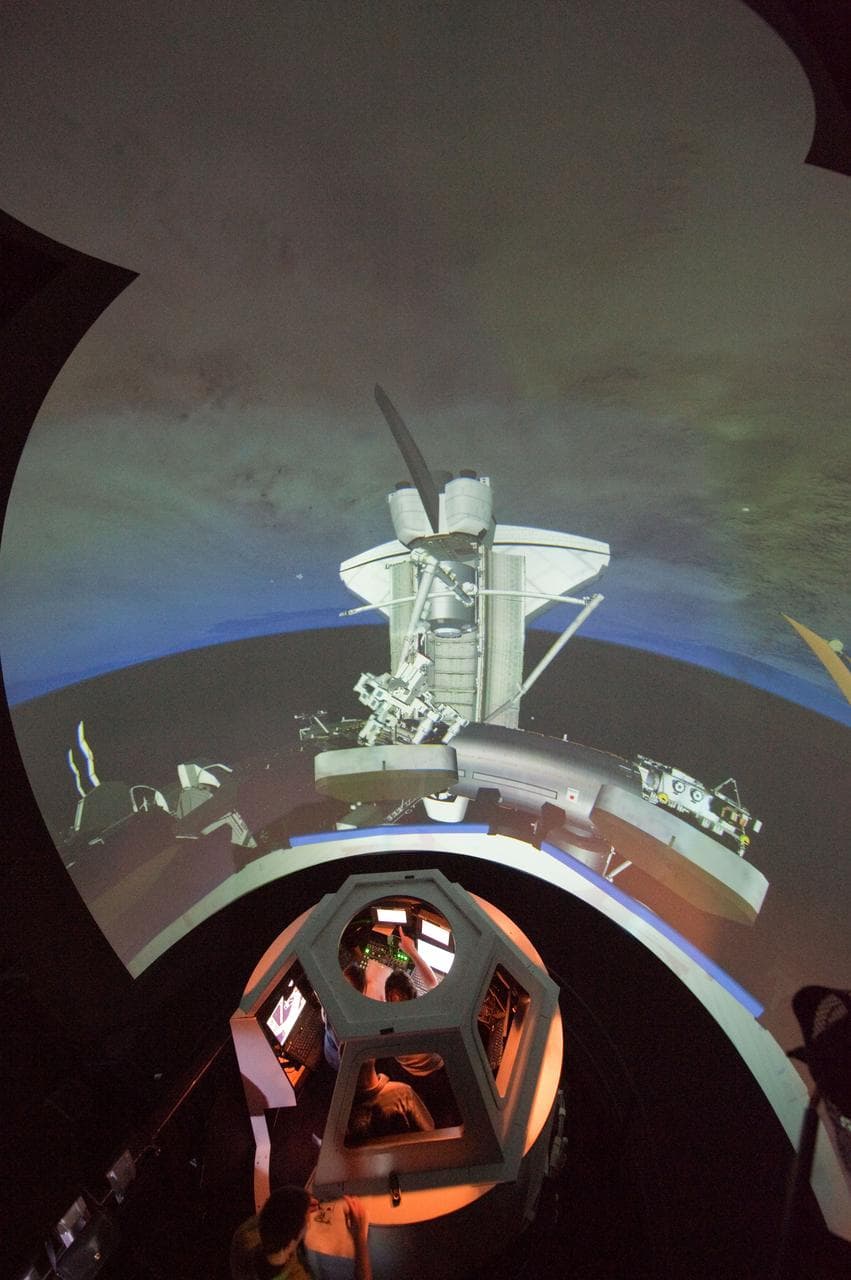 STS-133 crew members Mike Barratt and Nicole Stott in cupola