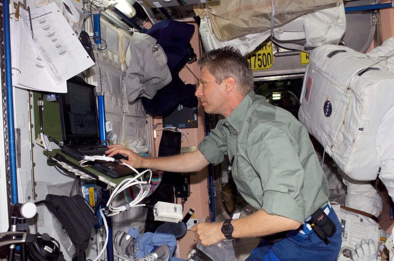 Reiter uses a computer in the Node 1 module during STS-121/Exp. 13 OPS