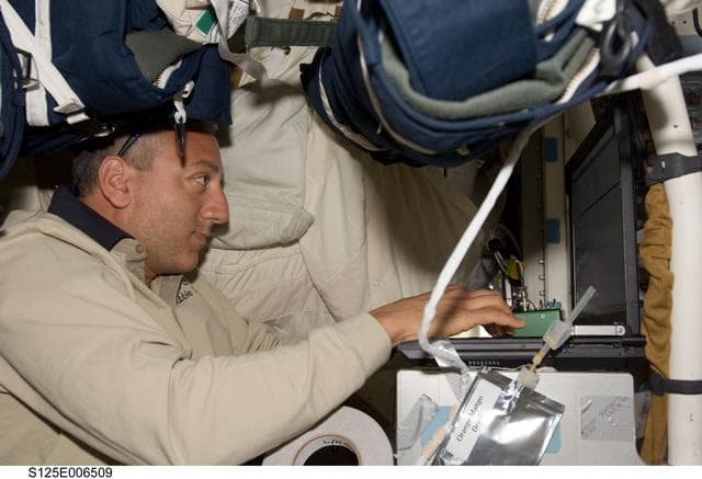 Massimino in the Shuttle Atlantis Middeck