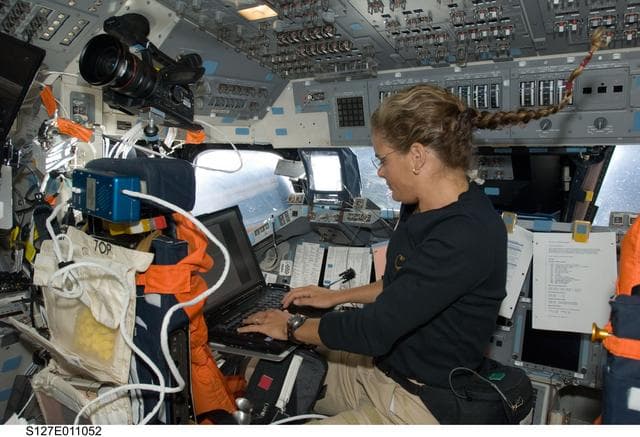 Payette uses computer in the aft FD on Space Shuttle Endeavour