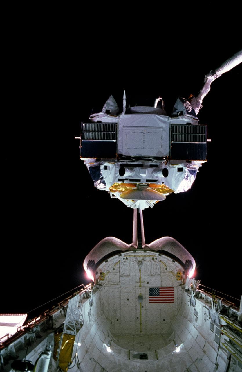 GRO lifted from payload bay by the RMS