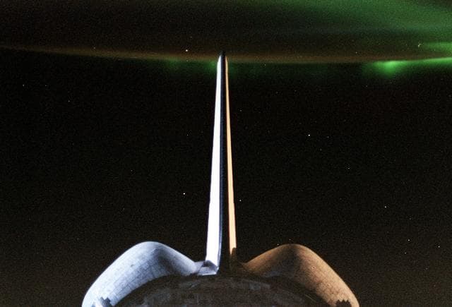 Sunrise reflected on the orbiter's vertical stabilizer