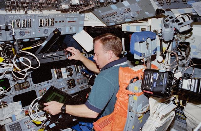 Lindsey works with several laptop computers in the flight deck