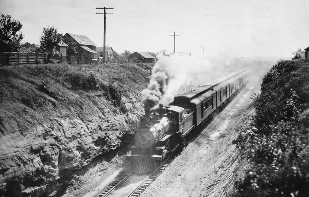 Vintage 4-4-0 working hard with 6 cars in a cut.