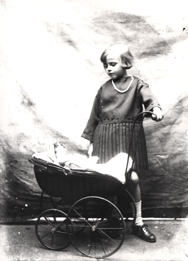 059336:Studio portrait of a girl with a doll's pram Unknown c.1925