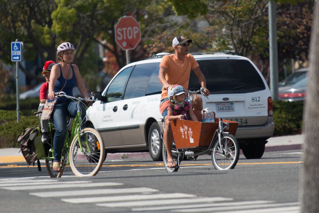 Family on bicycles crossing crosswalk in Berkeley