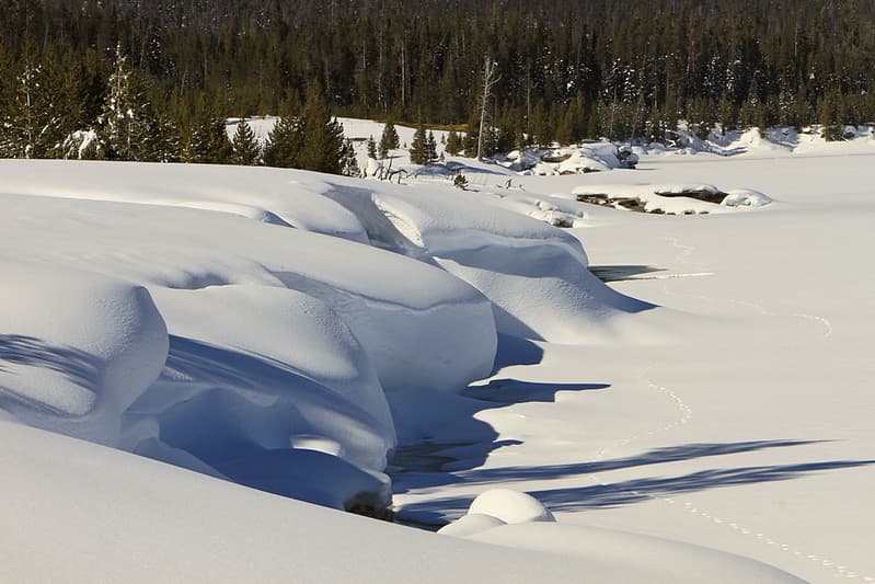 Snow drifts on Yellowstone Lake shore at West Thumb Geyser Basin