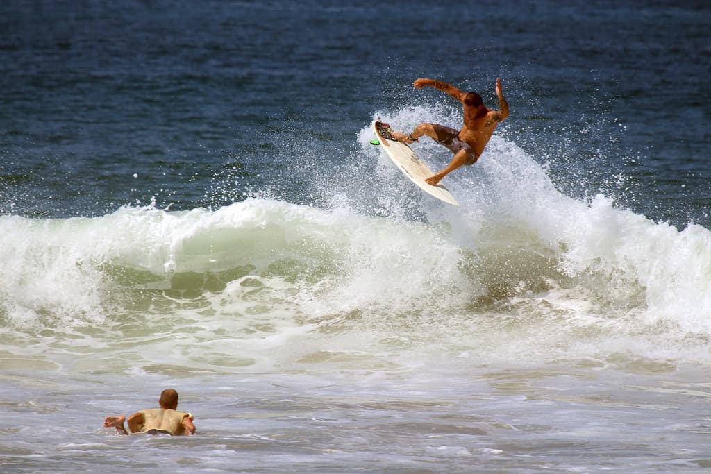 Surfer Surfing on Wave in Ocean