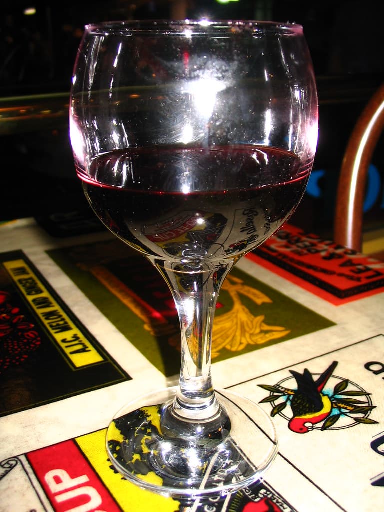 Wine glass in front of window flash