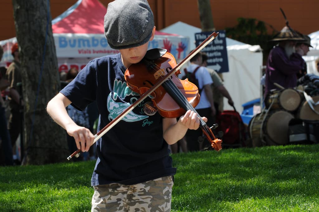 Child street performer with violin 1