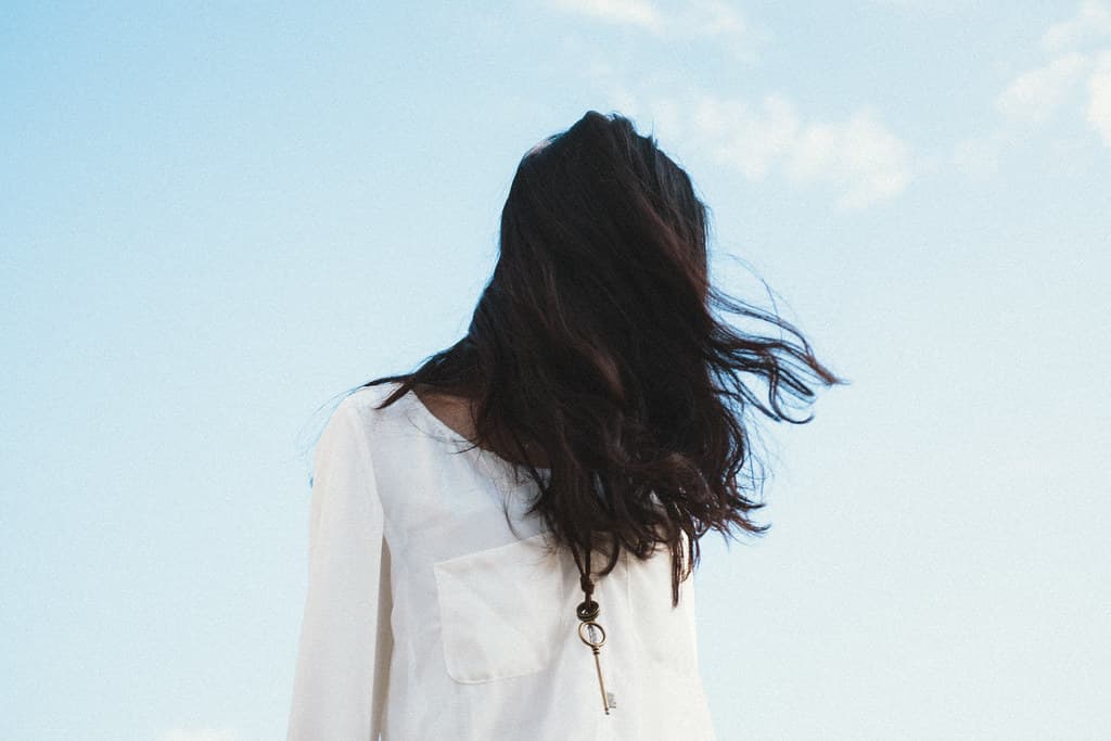 Girl with Black Hair Wearing a Key Necklace