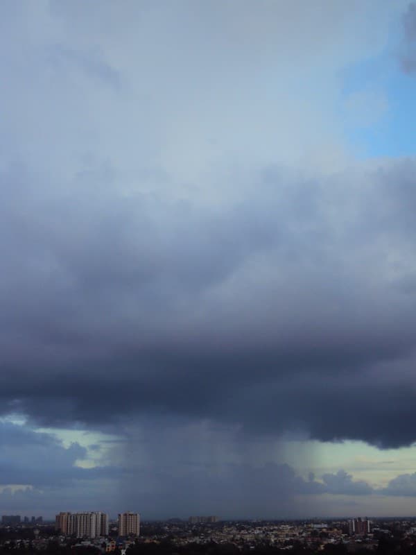 Tall cloud raining its shower
