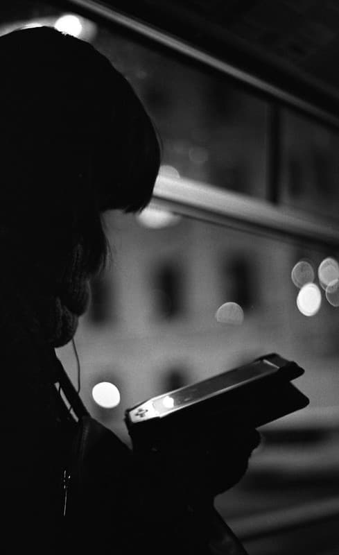 Praktica BC1 - Girl Reading a Smartphone at Tram Window